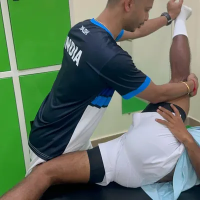 A hands-on approach is key to understanding and treating musculoskeletal pain. Here, I am applying manual pressure to release tension in the hamstring and improve lower back mobility for a patient.