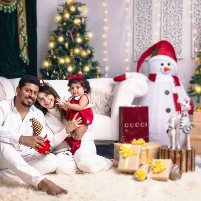 The best gift around the Christmas tree is a happy family wrapped up in each other. A beautiful family portrait radiating warmth and joy.