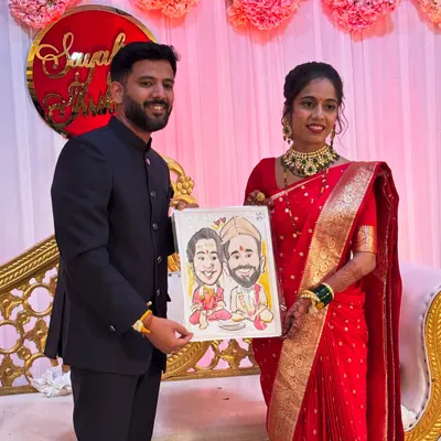 A beautiful couple posing with their wedding caricature. This is a popular option for the bride and groom to get a unique portrait on their special day.