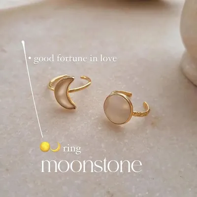 A duo of Moonstone rings for good fortune in love. The crescent moon ring connects to intuition, while the round Saturn ring attracts abundance. Both are powerful talismans.