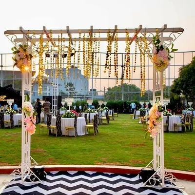 An overview of the stunning outdoor setup for the 60th birthday bash. We designed the entire space with a hanging floral installation, themed guest seating, and a striking chevron-patterned walkway.