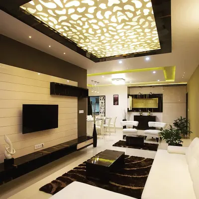 The finished living room in a luxury apartment, where the custom backlit ceiling is the main highlight. We used a mix of white sofas, dark wood furniture, and plush rugs to create a space that is both visually striking and comfortable.
