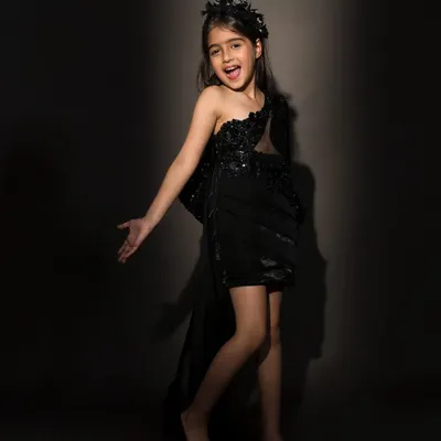 Steal the spotlight in this luxurious one shoulder black dress, embellished with sequins and featuring a dramatic side tail.