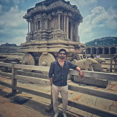 Standing next to the world-famous Stone Chariot at the Vittala Temple complex in Hampi. It's a masterpiece of ancient Indian architecture.