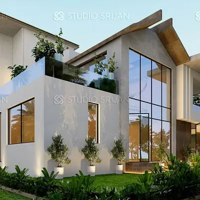 A 738 sq. yard villa designed for a client in Coimbatore. This view highlights the double-height glass walls and asymmetrical rooflines, creating a dynamic structure that embraces natural light and its green surroundings.