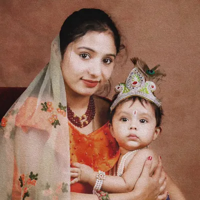 A beautiful mother and child portrait from a Janmashtami mini session. The baby is dressed as little Krishna, complete with a peacock feather crown.