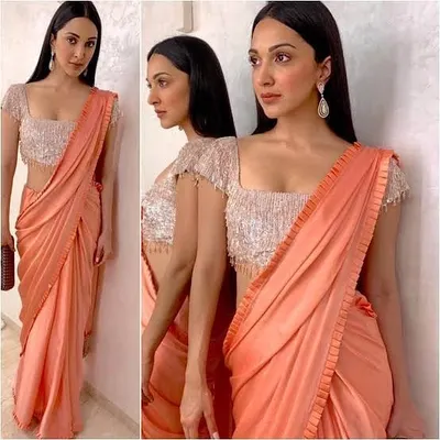A modern, pre-draped saree look with a shimmering sequin blouse. We can stitch trendy blouses with cap sleeves and custom necklines to go with your party wear sarees.