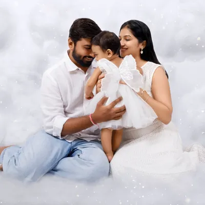 A heavenly first birthday theme for a little angel. This family portrait in a dreamy cloud set I created in my studio is a perfect example of a custom, magical milestone shoot.