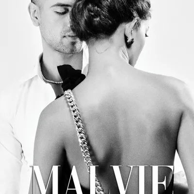 A published cover for Malvie Magazine, this black and white shot captures a quiet, intimate moment. The focus is on the back of the model, highlighting the chain detail of her dress strap, which serves as the central accessory in the frame.