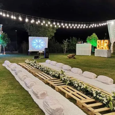 A perfect sit-down experience at a private farmhouse party in Nashik. We created a rustic and elegant low-seating arrangement for guests to dine under the stars.