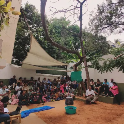 A packed audience of family and friends watches the children perform "The Bright Blue Jackal." Our theatre productions are a culmination of weeks of practice, costume making, and collaboration, filling our community with pride and joy.