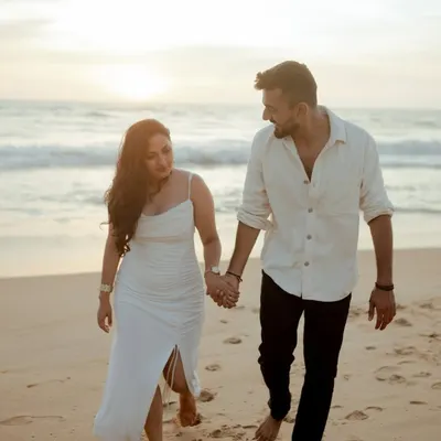 A candid shot of Nidhi and Ruchit walking along the beach in Goa. Their natural interaction and the soft evening light make this a perfect example of a relaxed and authentic pre-wedding photo.