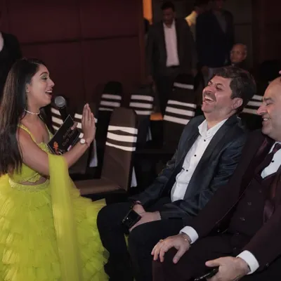My ultimate goal is to spread smiles. This candid shot captures a moment of pure laughter with guests, which is the most rewarding part of my job as an event host.