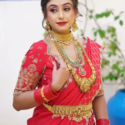 A beautiful red lehenga saree drape, perfect for a sangeet or engagement ceremony. The pallu is styled to create a graceful fall while being securely pinned.