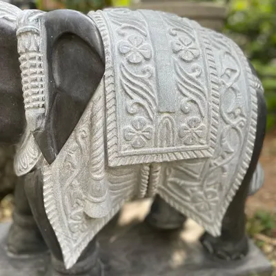 A close-up of the intricately carved blanket on one of our grand elephant statues, showcasing the detailed handiwork of our artisans.