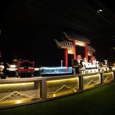 Our grand Pan-Asian buffet setup, complete with pagoda-style architectural elements and dramatic lighting. This station is designed to transport guests, offering an immersive experience into the world of Asian cuisine.