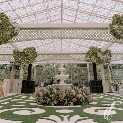 The centerpiece of our spring luncheon design was this beautiful three-tiered fountain surrounded by a bed of colorful flowers. The custom grass-and-paver style flooring and heart-shaped floral trees add a touch of whimsy and romance.