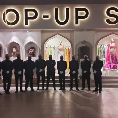Our team stands ready for an event with Pernia's Pop-Up Shop. We pride ourselves on our team's professionalism and coordinated service, ensuring a smooth experience for our high-profile clients.