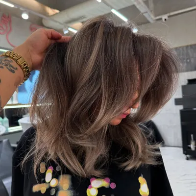 A beautiful blonde transformation with lots of volume and cool, ashy undertones. This look is modern, chic, and full of movement.