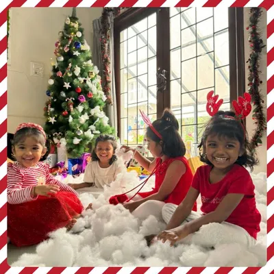 The pure joy of Christmas. Our students revel in a winter wonderland scene, complete with a festive tree and fluffy "snow," creating magical memories together.