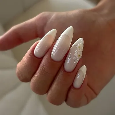 This is the epitome of the "clean girl" aesthetic. These flawless almond-shaped extensions are coated in a beautiful, semi-sheer milky white polish, with a subtle 3D floral accent for a touch of elegance.