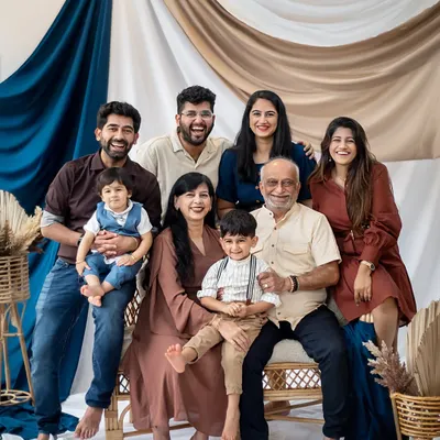 A beautiful, happy portrait of three generations together. I ensure everyone feels comfortable so we can capture genuine smiles and interactions in a classic studio setting.