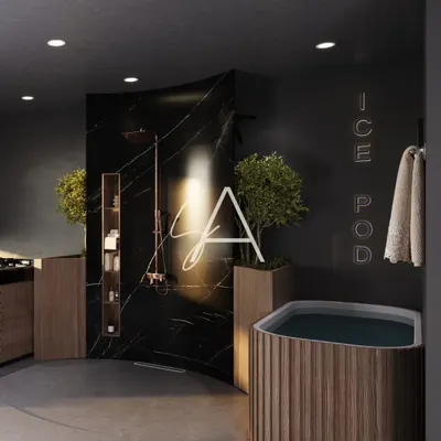 This is the 'Ice Pod' area in a private wellness center. We used a curved black marble wall for the shower and a wood-paneled tub to create a dramatic, spa-like atmosphere for post-workout recovery.