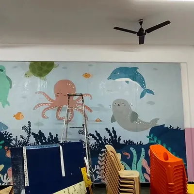 This underwater-themed mural is perfect for a school or playroom. The friendly sea creatures like the octopus, dolphin, and turtle create a welcoming and fun wall for kids.