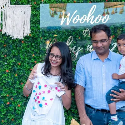 A candid moment of laughter at a baby shower as the parents-to-be look at a tiny baby outfit. These are the genuine, happy moments we strive to capture for you.