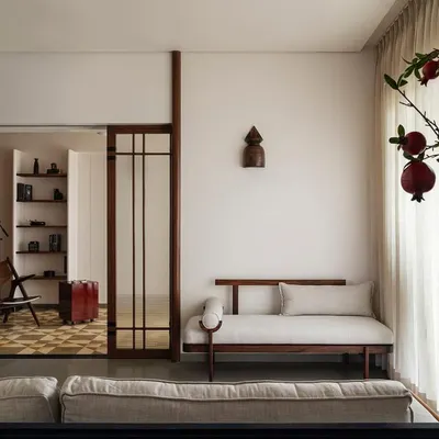 In Apartment 1005, we designed distinct but connected enclaves. This view shows the seamless transition from the bar and living area to the study, using architectural framing and consistent materiality to create a cohesive family mind map.