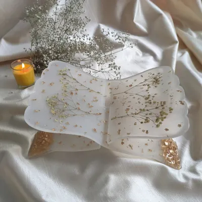This is my handmade resin holy book stand, also known as a rihal. It's designed to hold your sacred texts or any beloved book. This one features delicate baby's breath and gold flakes for a peaceful, elegant look.