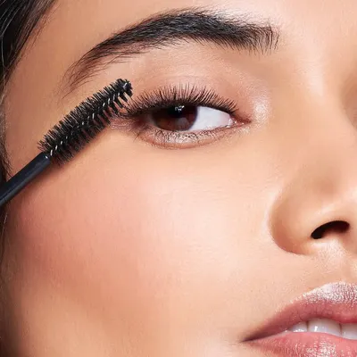 A macro shot for a Lovechild by Masaba product launch, demonstrating the application of mascara. This type of beauty photography requires meticulous attention to detail for clean, clump-free lashes and perfect skin.