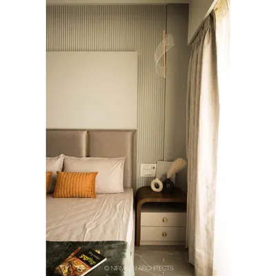 This master bedroom features a serene design with a fluted wall panel behind the bed. The neutral tones and soft fabrics create a calm and restful environment, perfect for unwinding.
