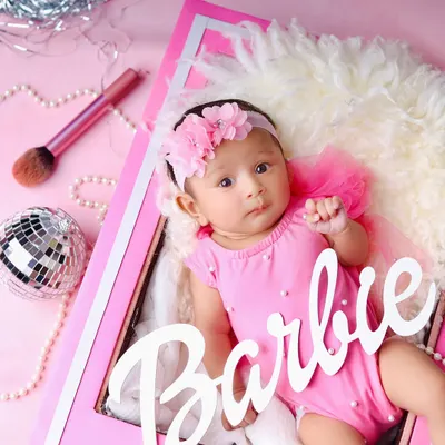 Come on Barbie, let's go party! This adorable baby is ready for her close-up in a fantastic Barbie-themed shoot, complete with a pink frame, a disco ball, and makeup brushes.