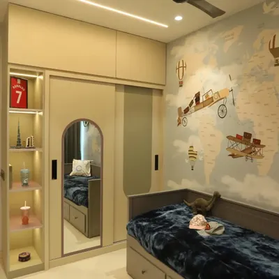 An adventure-themed kid's room, perfect for a young explorer. The world map wallpaper, airplane motifs, and pull-out bed with storage make this room both fun and functional.