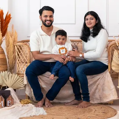 A classic family pose in our popular boho setup. The natural elements and warm lighting create a cozy and inviting atmosphere for a timeless family photograph.