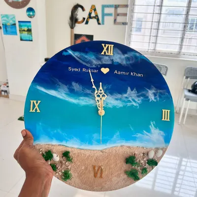 A beautiful personalized resin beach clock created by a couple in our workshop. It's a wonderful way to commemorate a special bond while creating a functional piece of art for your home.
