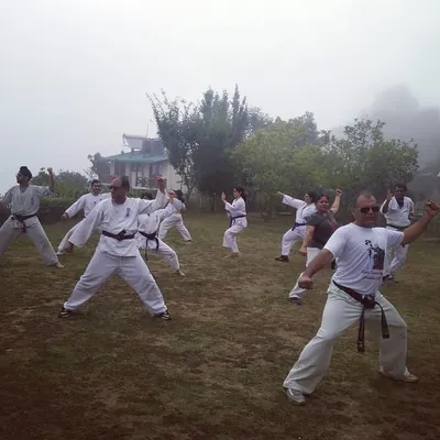 Training continues regardless of the weather. Here, our karateka practice their kata with precision and focus during a misty morning session, demonstrating the discipline required to perfect their form in any condition.