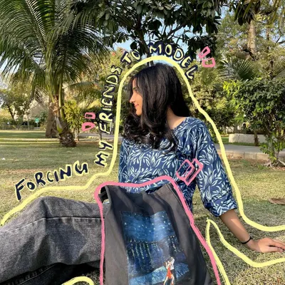 I always force my friends to model my creations! Here's a custom tote bag I painted, perfect for carrying your essentials with an artistic flair.