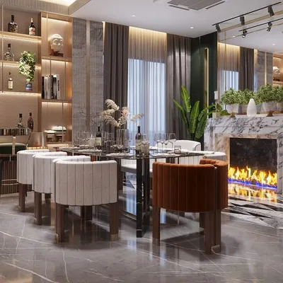 A view of the dining and bar area from our Sushant Lok project. We designed this space for entertaining, with a custom bar, an elegant dining set, and a modern fireplace feature. The material palette of marble, wood, and metal, combined with lush greenery, creates a sophisticated and welcoming atmosphere.