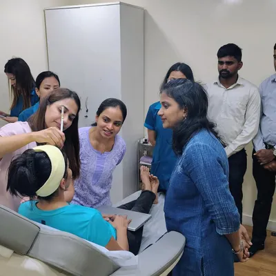 I am demonstrating a precise injection technique during a hands-on botulinum toxin workshop. I believe in close supervision to help fellow dermatologists master the nuances of facial anatomy and achieve safe, natural-looking results for their patients.