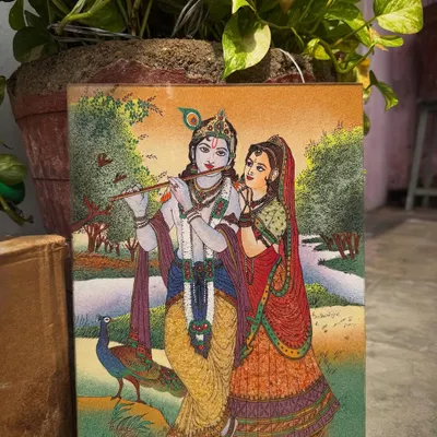 I created this piece to portray the divine love between Radha and Krishna. Every element, from the serene landscape to the peacock at their feet, is rendered with natural gemstones to reflect the harmony and spiritual connection they represent. This artwork is intended to bring a feeling of peace and devotion into your home.