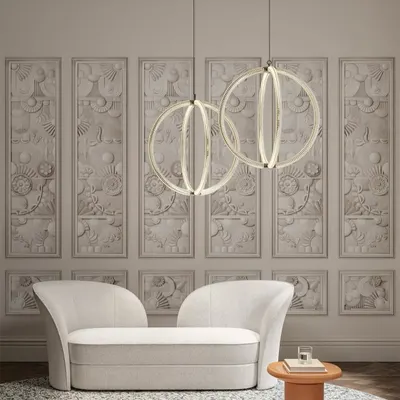 Two Luminora pendants by Cristina Celestino for Moooi hang like celestial bodies in a serene, classically inspired room. Their geometric purity and soft glow create a harmonious balance with the ornate wall panels, showcasing a modern take on grandeur.
