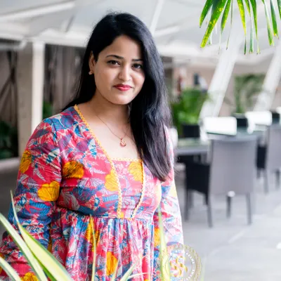 An outdoor setting can bring a different energy to your professional photos. This portrait, taken on a patio with natural foliage, has a relaxed and approachable feel, making it suitable for authors, consultants, or anyone wanting a lifestyle-oriented image.