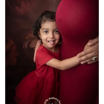 The bond between a big sister and her unborn sibling is just magical. I love this playful moment, a sweet hug for the baby bump filled with so much love and excitement.