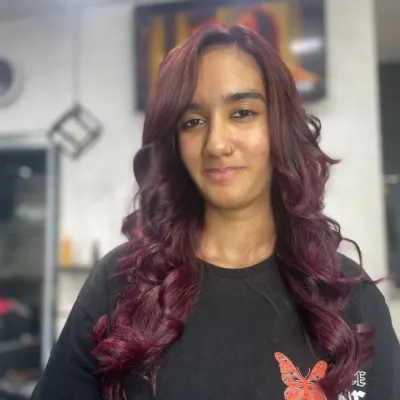 A beautiful example of a rich, wine-red hair color. The soft curls enhance the multi-tonal quality of the shade, showing off deep cherry and burgundy notes.