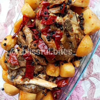 My Lamb Roast is a complete meal, featuring tender, bone-in lamb and soft potatoes roasted together. The meat is coated in a thick masala and garnished with whole red chilies and black peppercorns for a bold, aromatic flavor.
