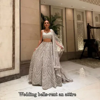 My gorgeous client dazzling in a heavy silver lehenga. She looks like a dream, twirling and shining at her event. This is the magic of renting luxury!