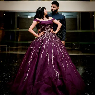 A powerful portrait of the couple taken at their reception venue. We positioned them to create a strong, loving pose that stands out against the dark, reflective flooring and modern architecture.