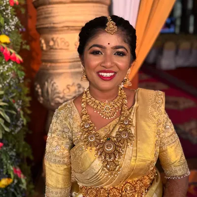 A radiant bride ready for her muhurtham. This is a completely unedited photo, showcasing the true glow and finish of her makeup in natural lighting.
